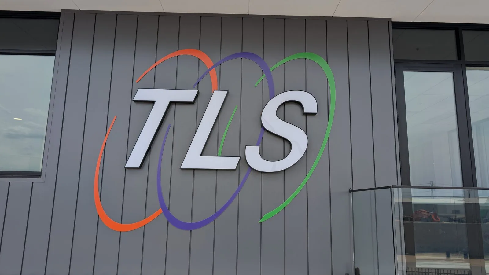 Illuminated facility signage across a commercial industrial building