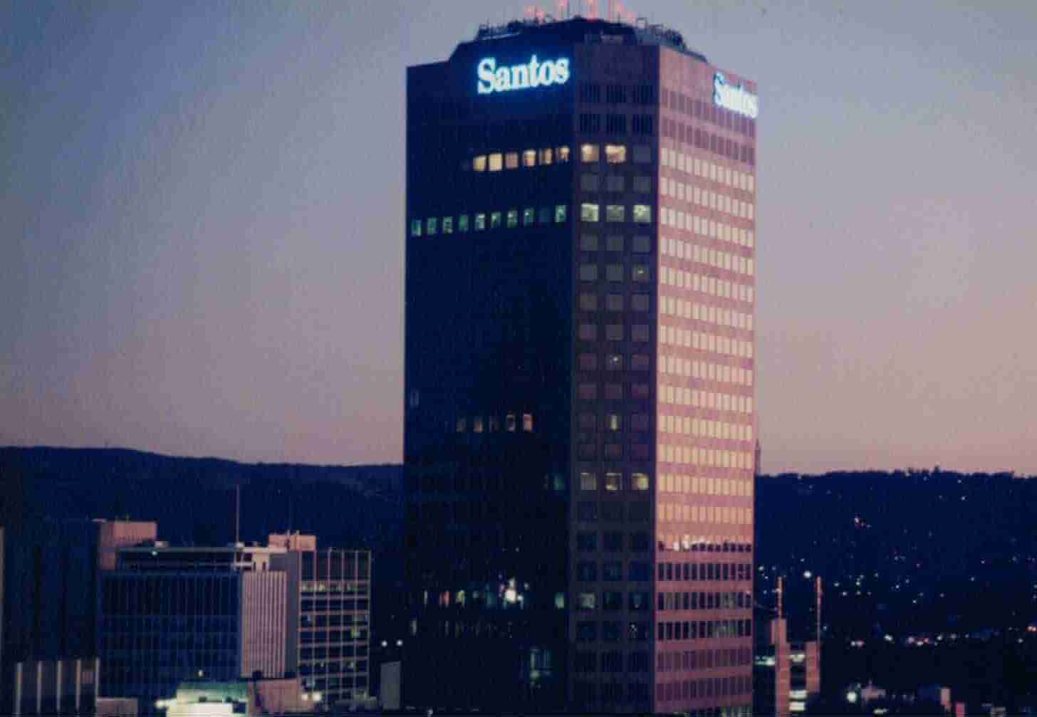 Santos illuminated rooftop building sign on high-rise at night