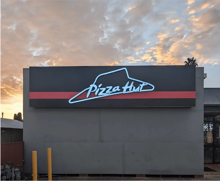 Pizza Hut sign at sunset