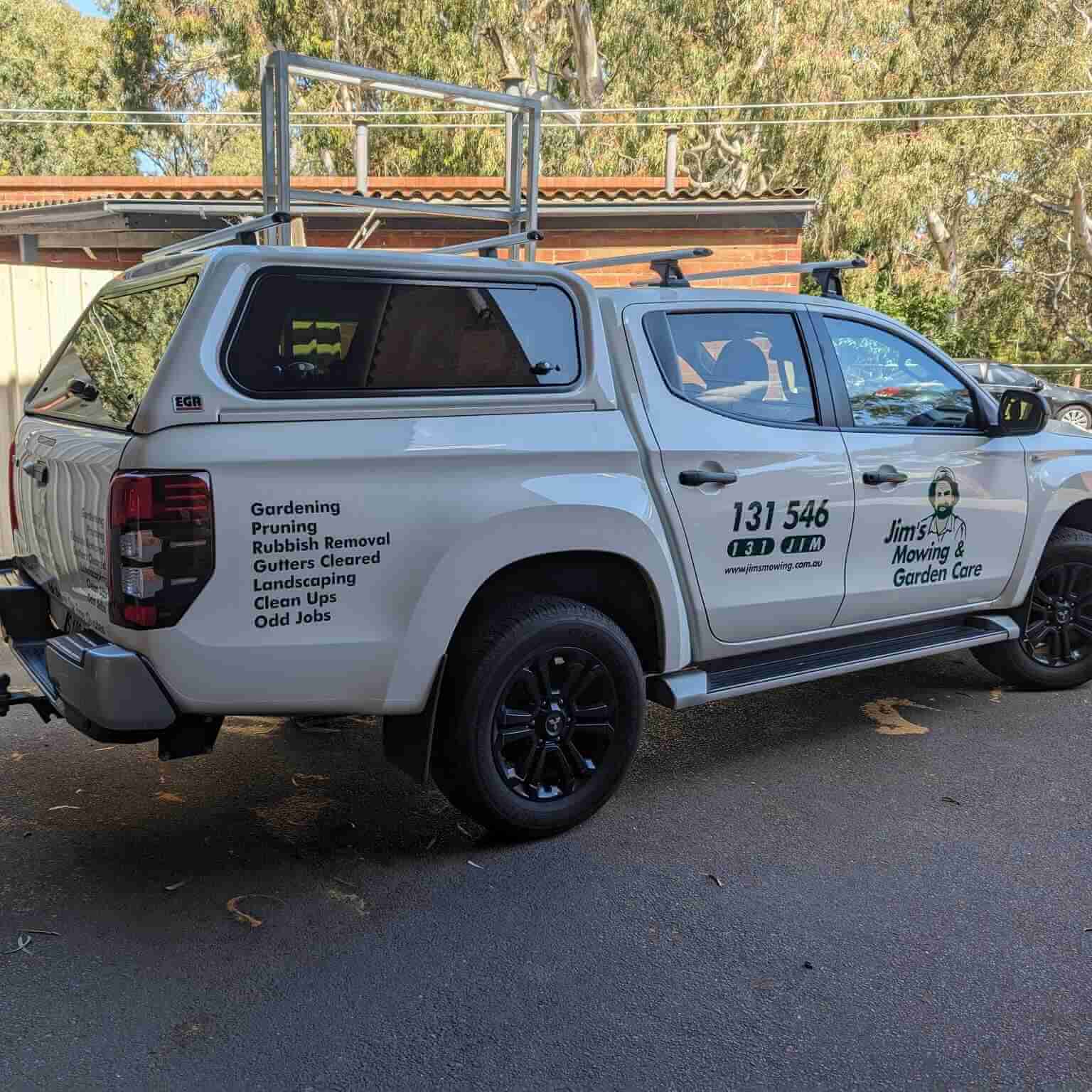 Vehicle with gardening service decals.