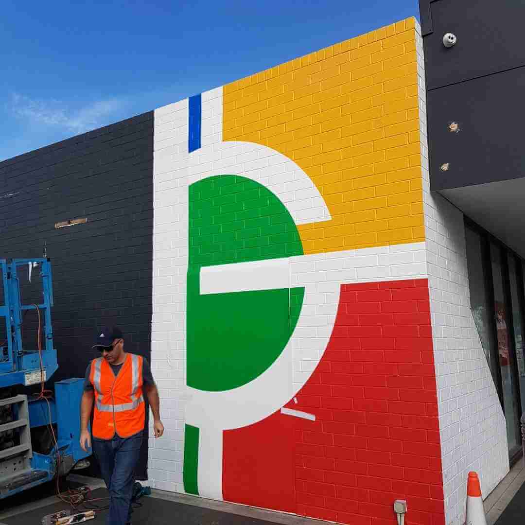Building sign installed on a brick facade during new construction