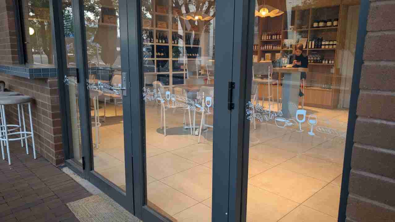 White vinyl café branding applied to glass door entrance