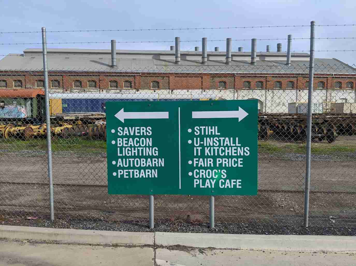 Green construction services panel signage listing earthmoving and fabrication services