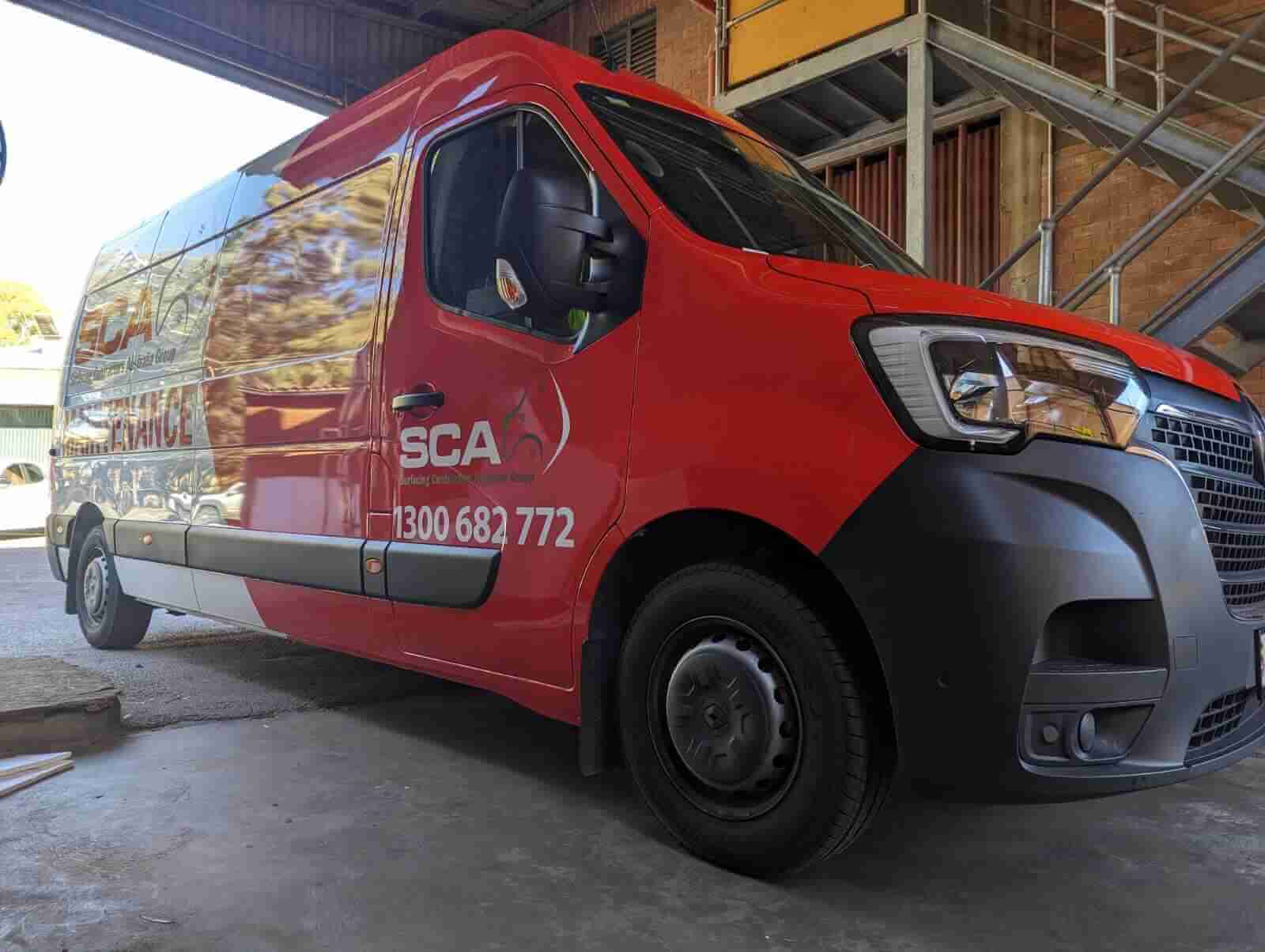 Red service van parked indoors.