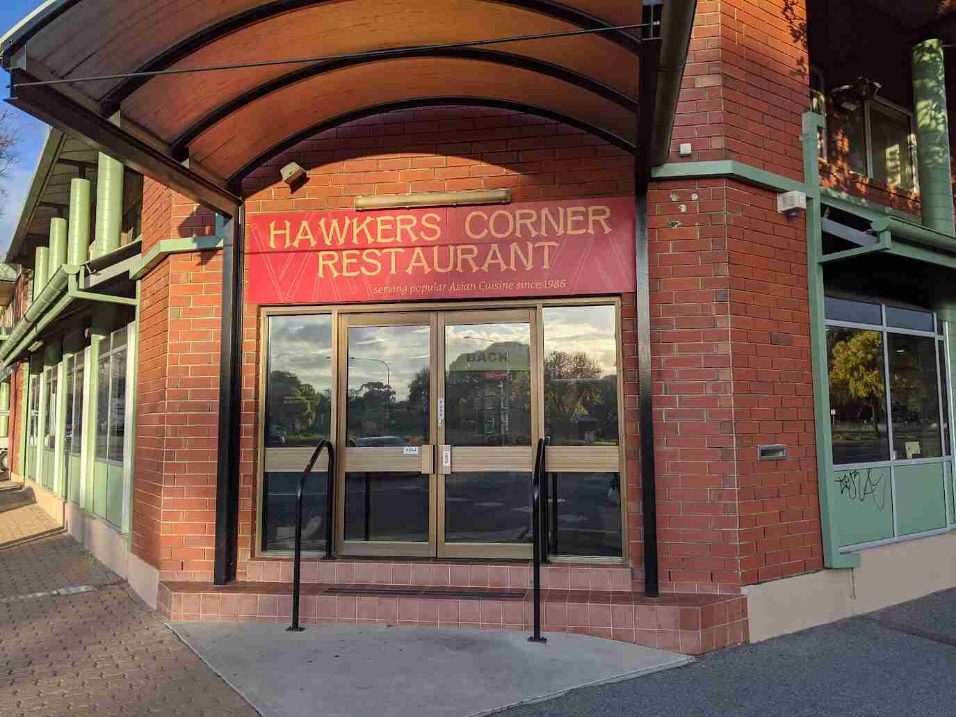 Hawkers Corner Restaurant red entrance signage under arched canopy