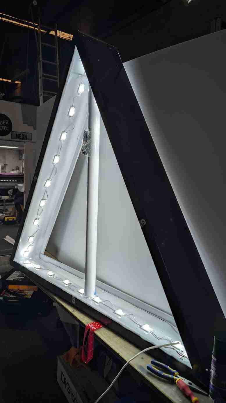 Illuminated triangular light frame