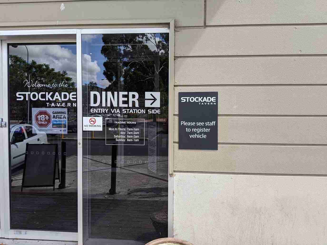 Diner glass door signage with white vinyl branding and business hours