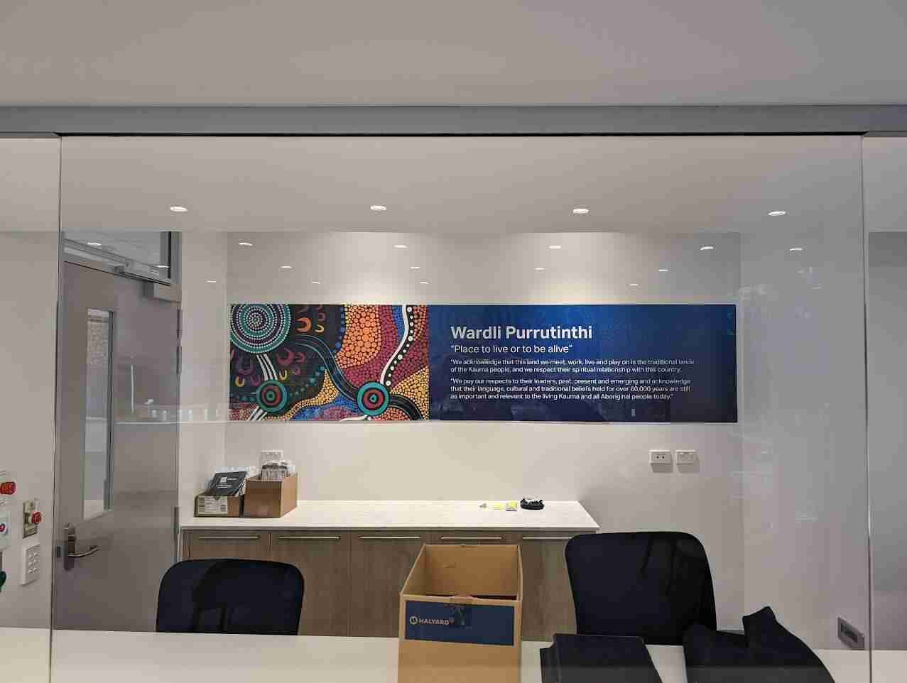 William Buck branded reception wall signage with blue graphic panel