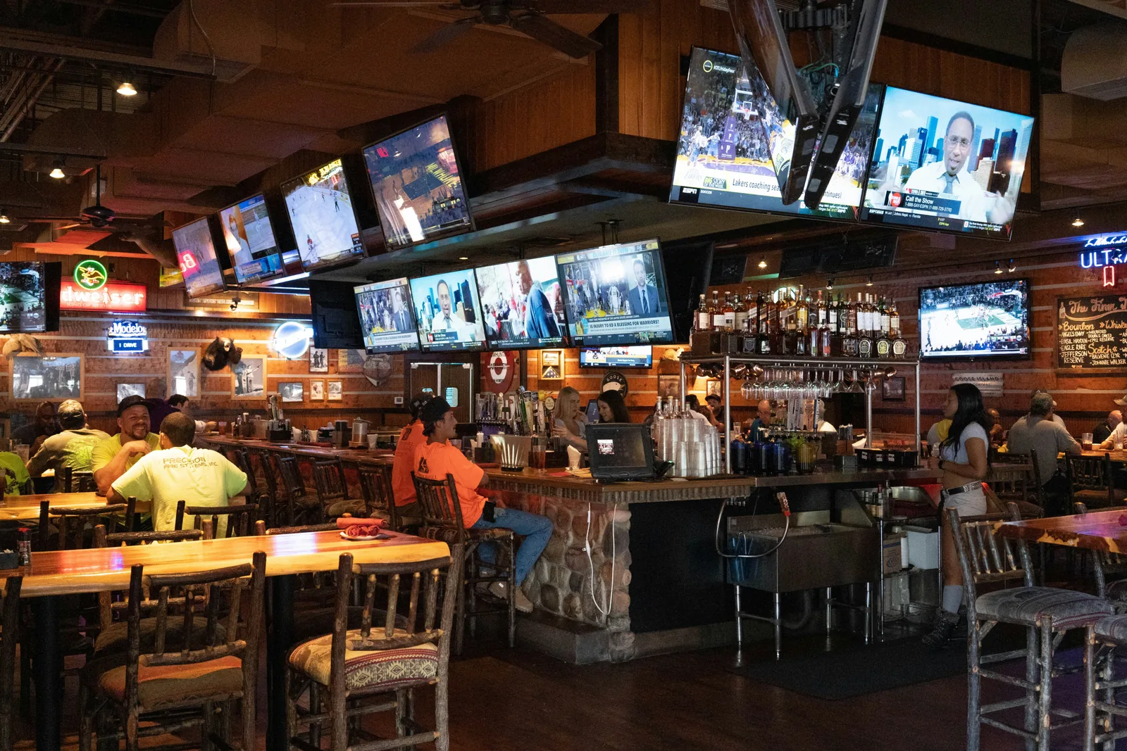 LED screens displaying live sport throughout a busy pub sports bar