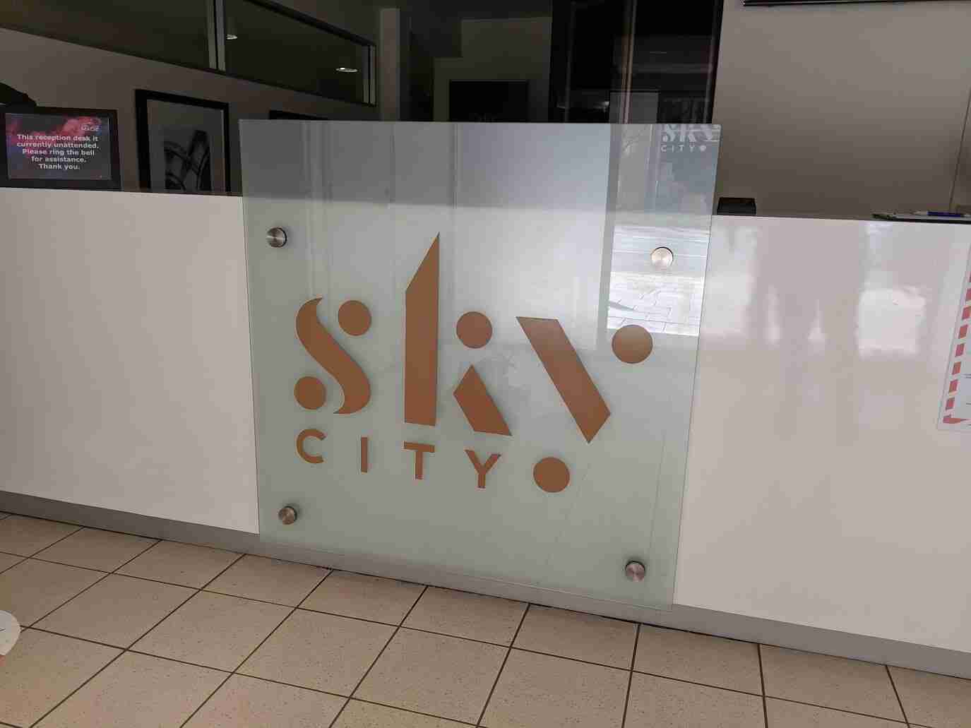 SkyCity frosted glass signage with copper-toned logo in entry area