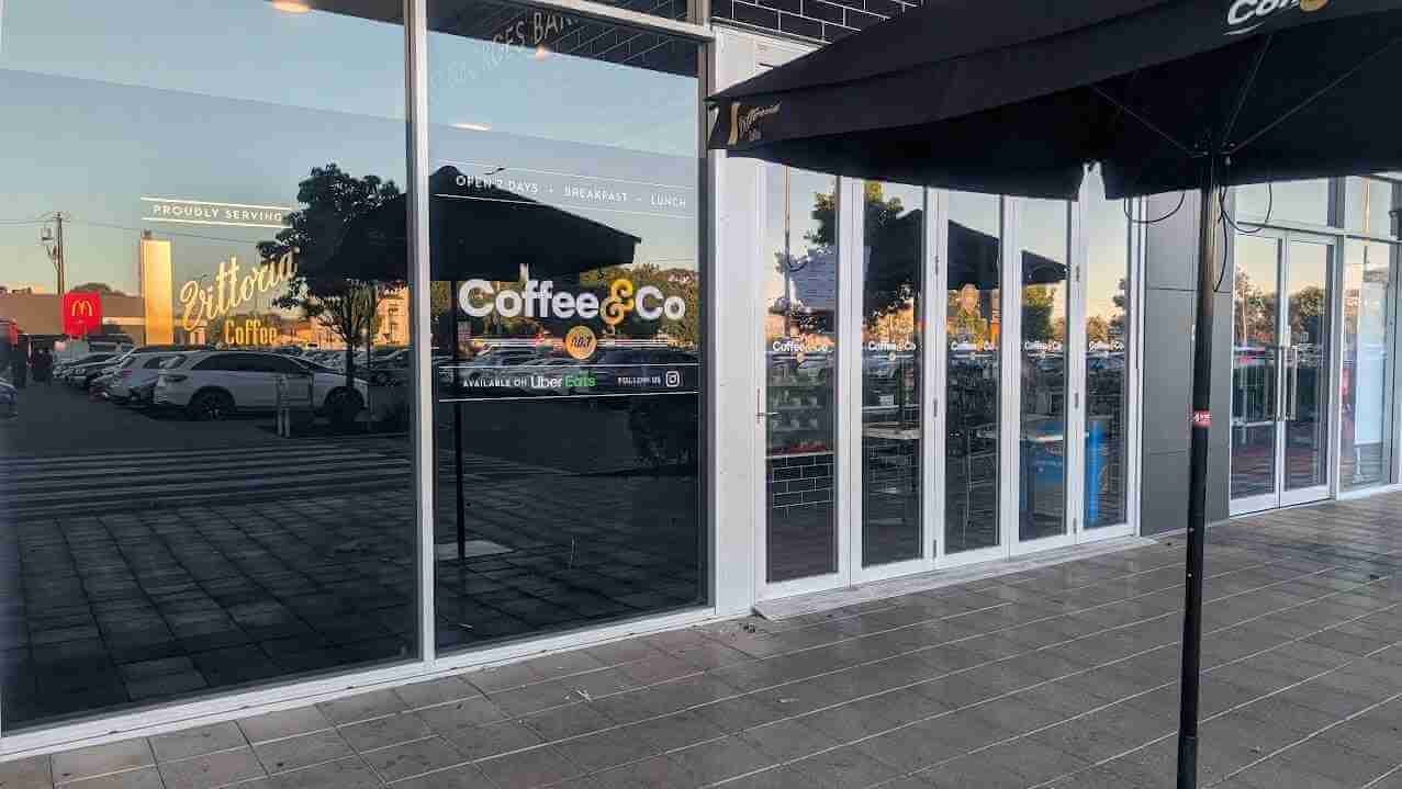 Coffee & Co branded window graphics installed on commercial storefront