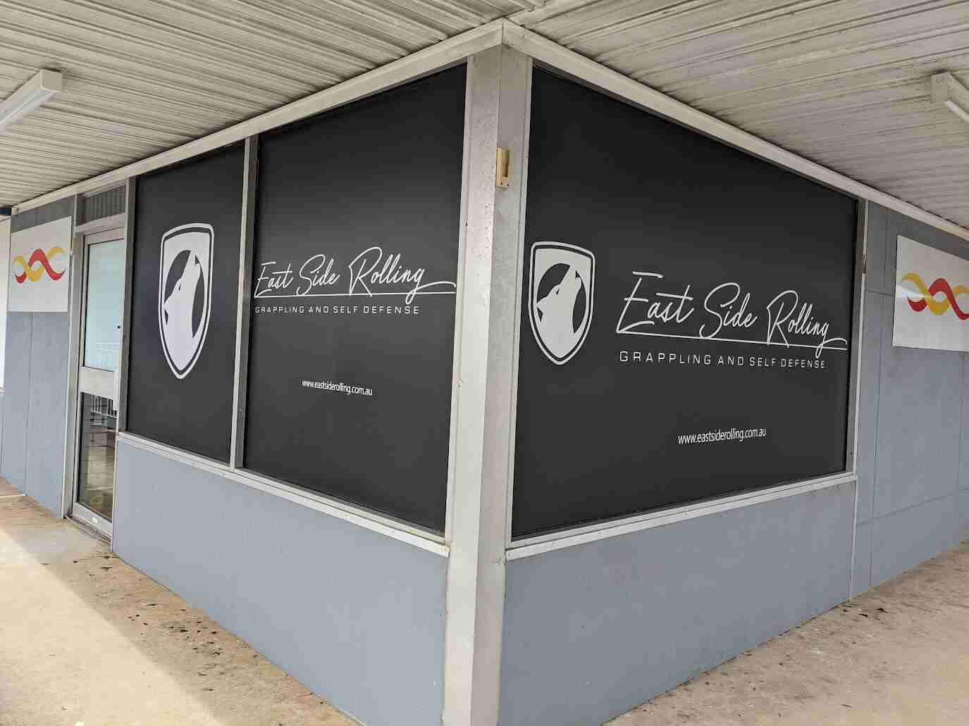 Monochrome window signage with logo and service list