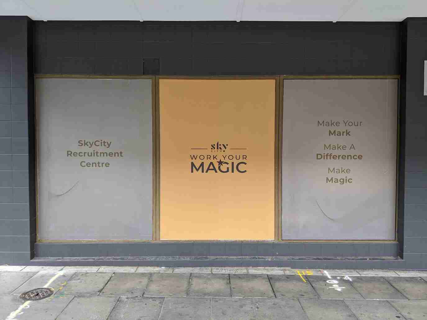 Gold window signage featuring logo and class listings