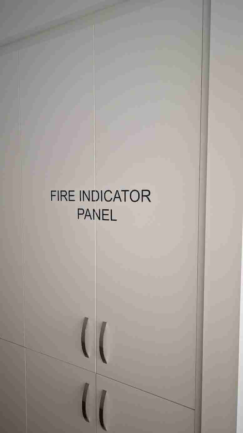 Fire Indicator Panel door sign in black lettering on white cabinet